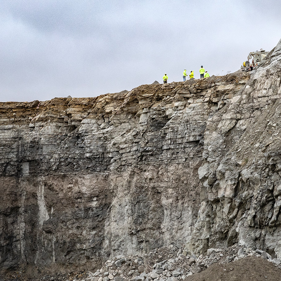 a group of people standing above a mine