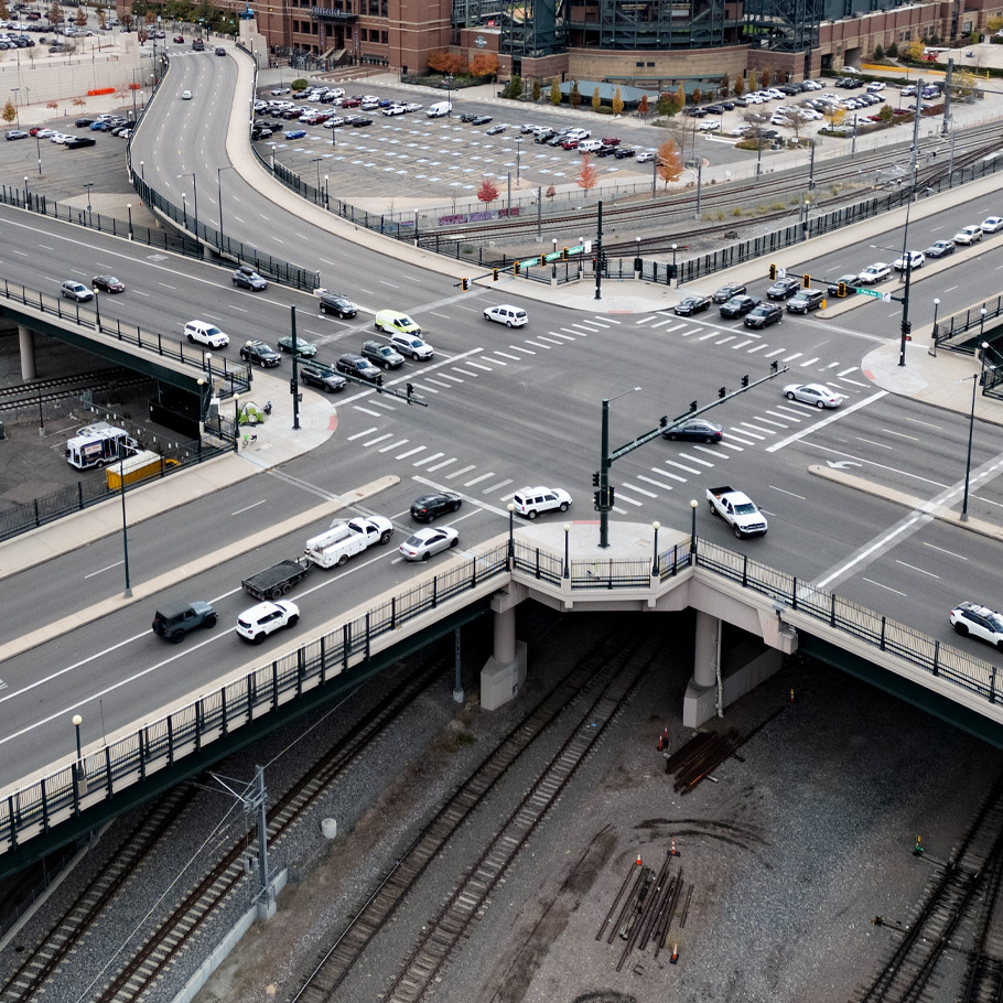 a city street with cars and a bridge
