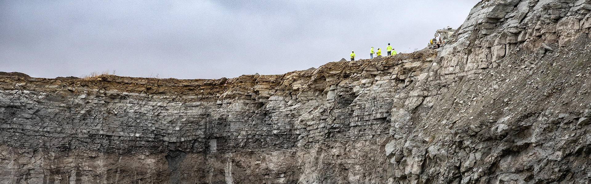 a group of people standing above a mine
